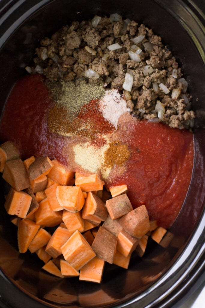 ground beef and sweet potato chili in a crockpot before cooking