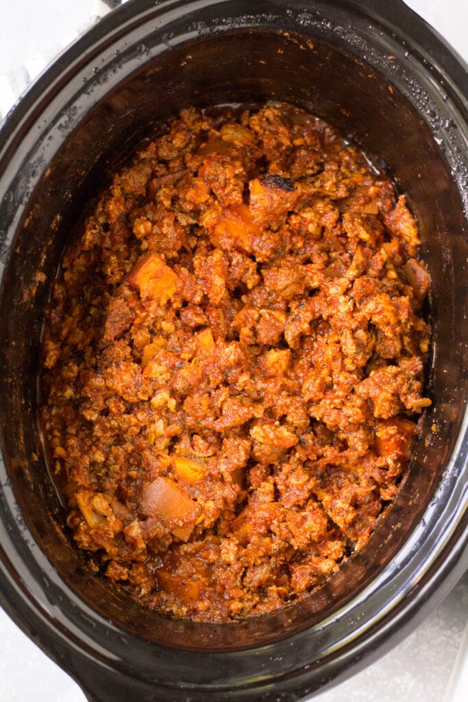 a crockpot filled with ground beef sweet potato chili