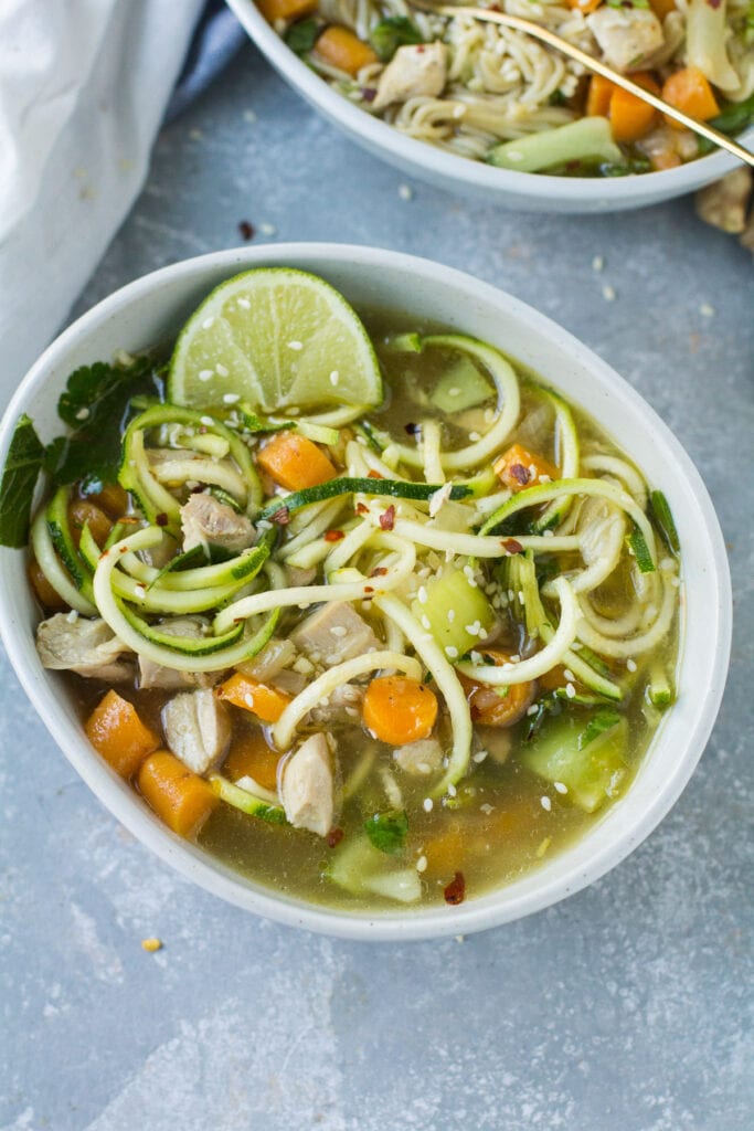 An overhead shot of a Asian Chicken Soup made keto, paleo and whole30 friendly with zucchini noodles.