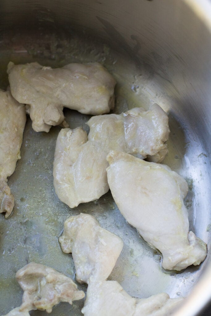 chicken browning for asian chicken soup in a large soup pot