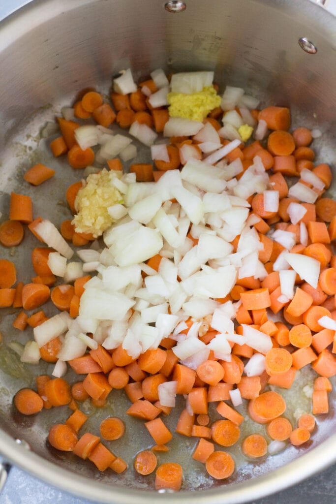 veggies sauteing for asian chicken soup in a soup pot