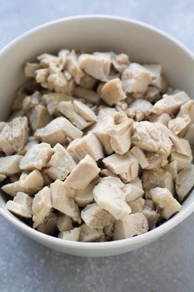 diced chicken in a bowl getting ready to be added to asian chicken soup