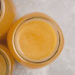 Turkey Broth in a glass mason jar on a grey background