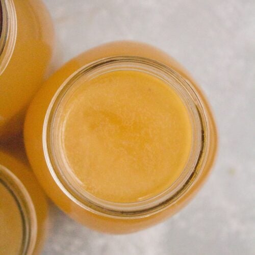 Turkey Broth in a glass mason jar on a grey background