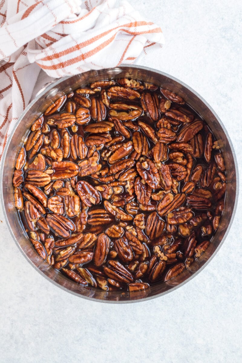 Pecan pie filling in a bowl on a white background.