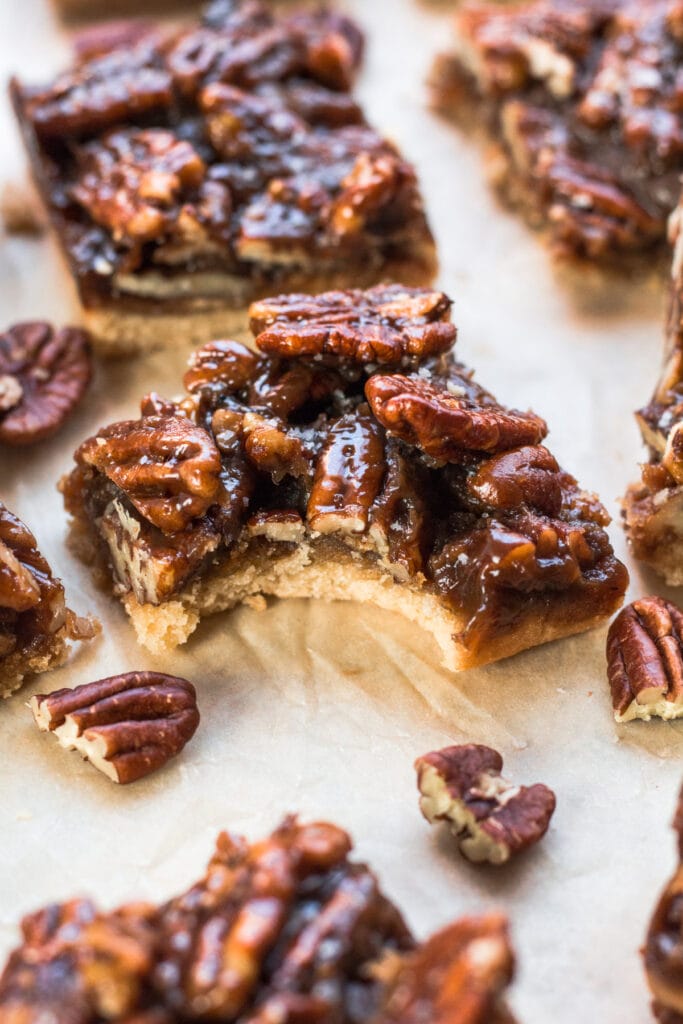 A close up of a healthy pecan pie bar with a bite taken out of it
