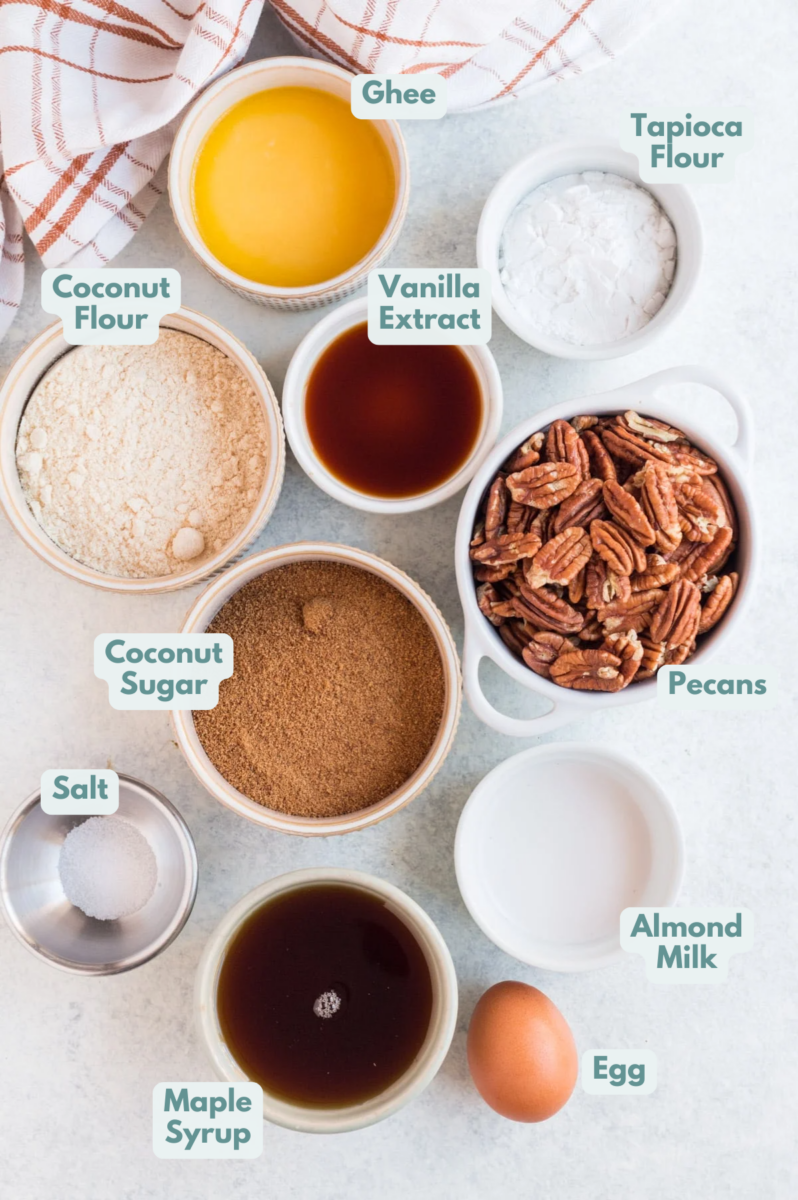 Ingredients for Healthy Pecan Pie Bars in small white bowls on a grey background