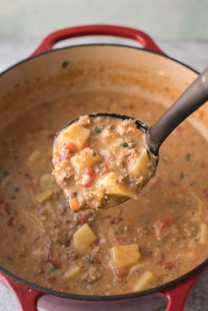 A ladle scooping up keto cheeseburger soup