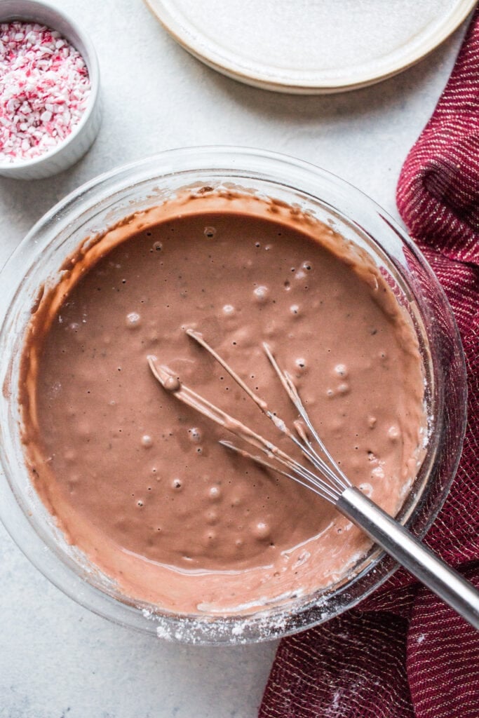 Chocolate mint muffin batter being mixed together in a bowl