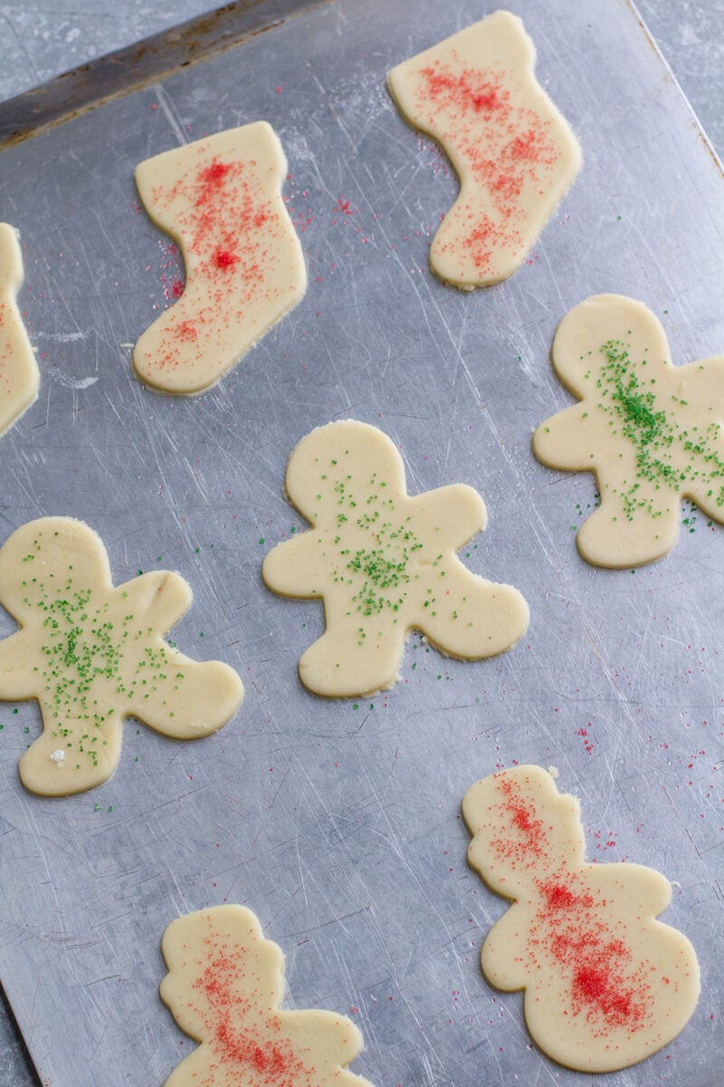 Uncooked sugar cookies on a cookie sheet.