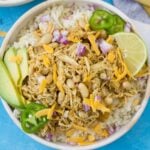 A close up of healthy chicken chili in a white bowl on a bright blue background