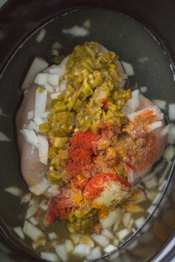 A close up of healthy chicken chili in a crockpot before being cooked
