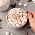 Healthy Hot Chocolate in a white mug on a grey. background with marshmallows