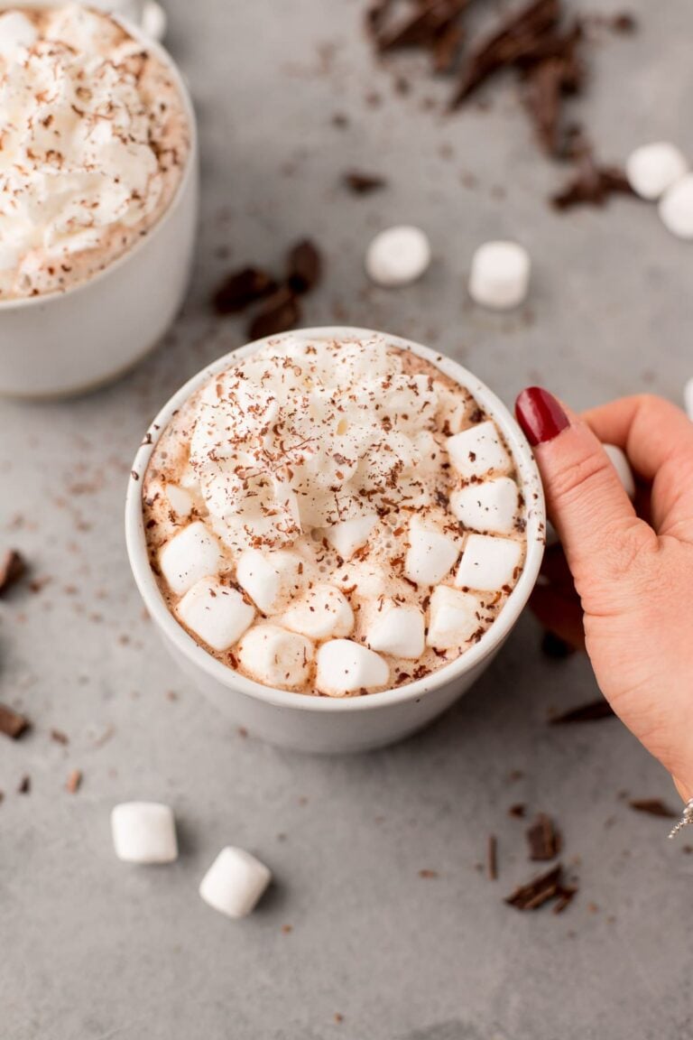 Healthy Hot Chocolate in a white mug on a grey. background with marshmallows
