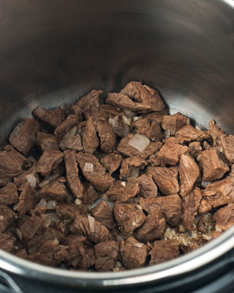 Stew meat being browned for instant pot beef stew