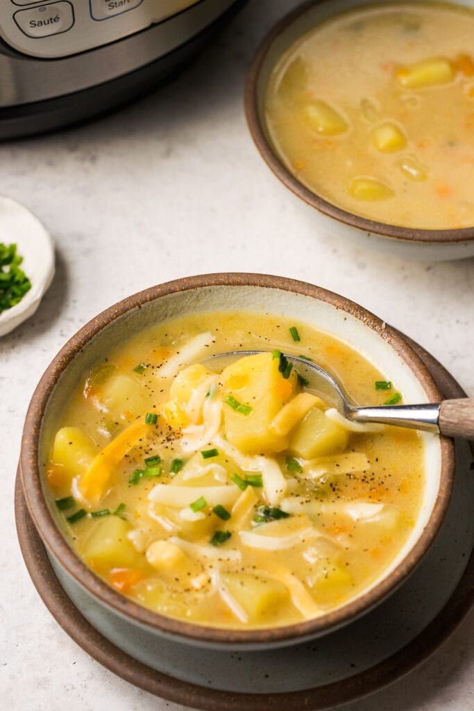 A bowl of loaded baked potato soup in the instant pot