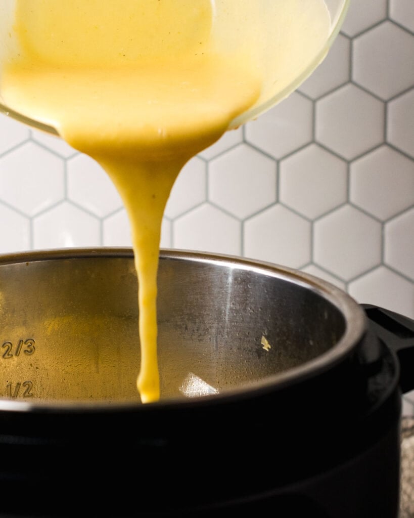 Creamy pressure cooker potato soup being poured back into the pot