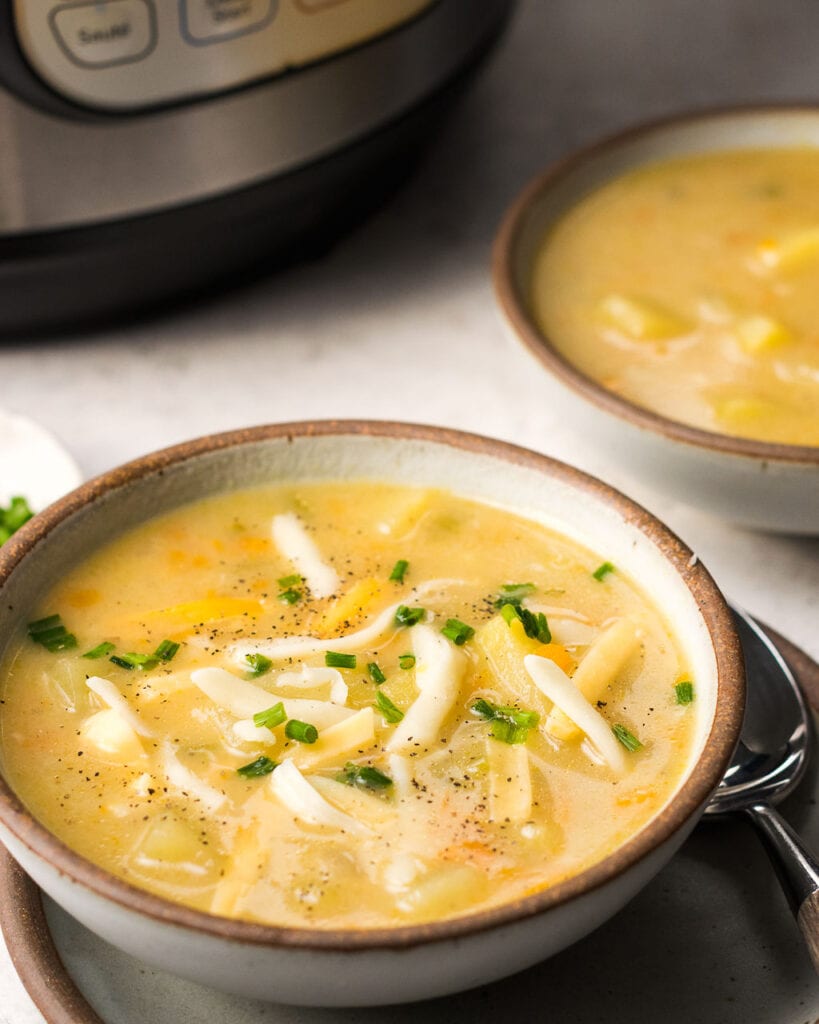 A bowl of potato soup off to the side near an instant pot