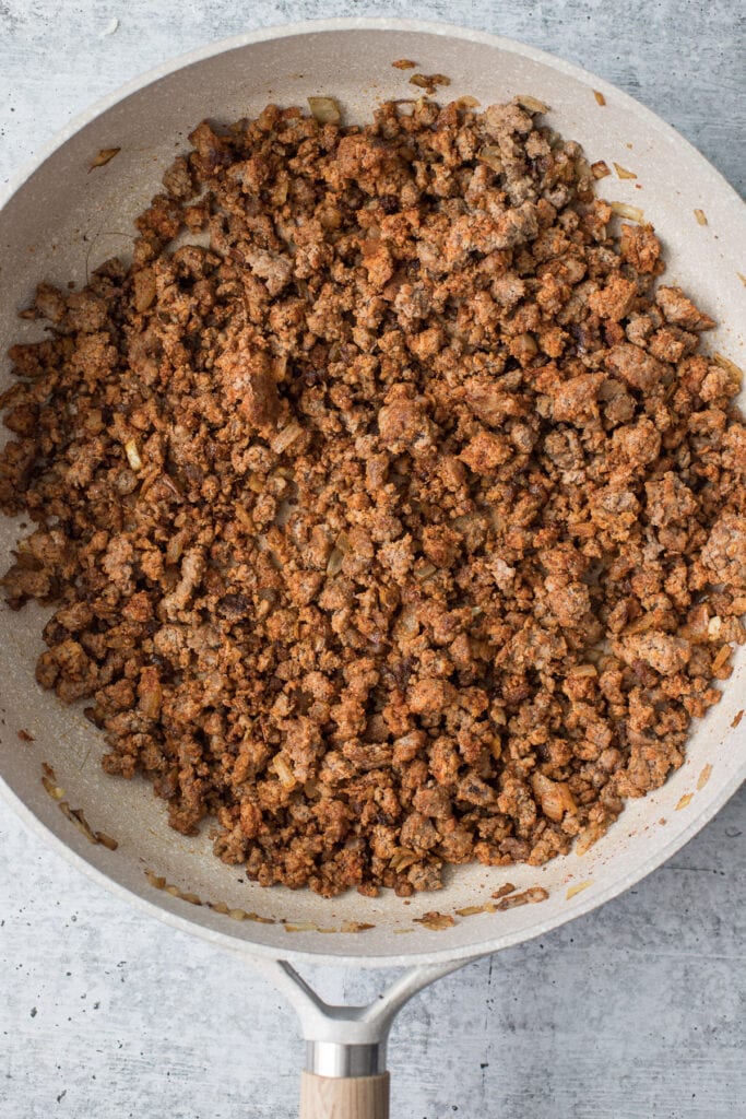 Grass fed round beef cooking in a sauté pan