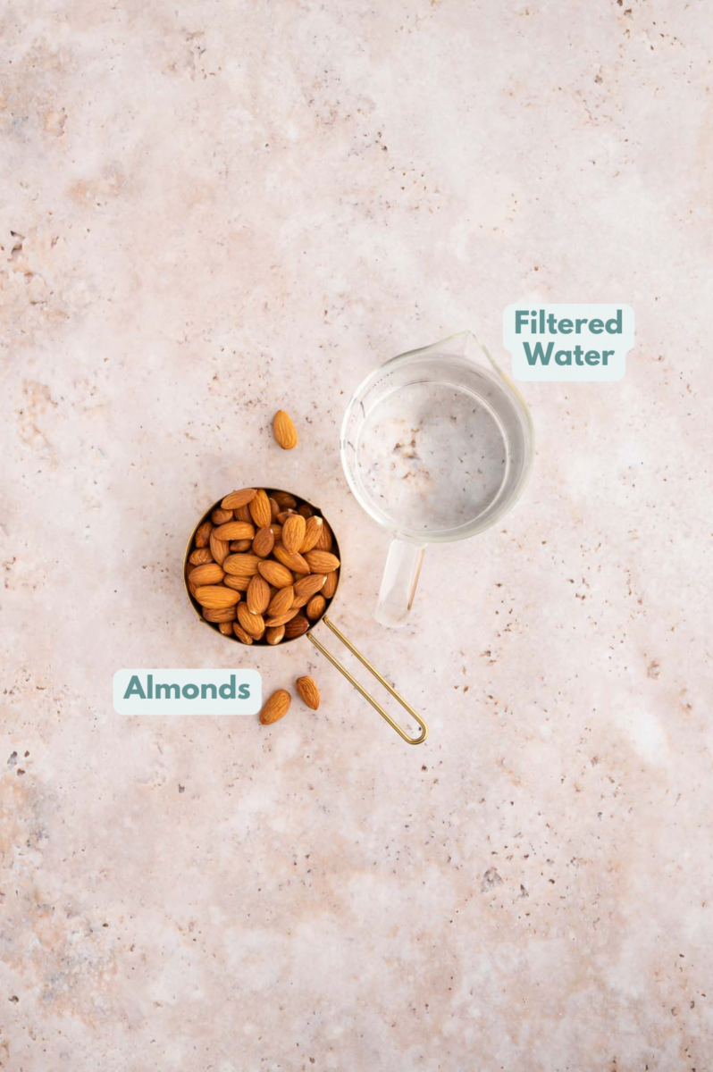 Whole30 Almond Milk Ingredients in a cup and measuring cup: almonds and water.