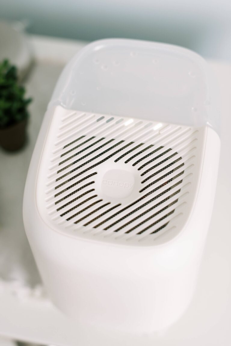 A close up of a canopy humidifier on a white nighstand