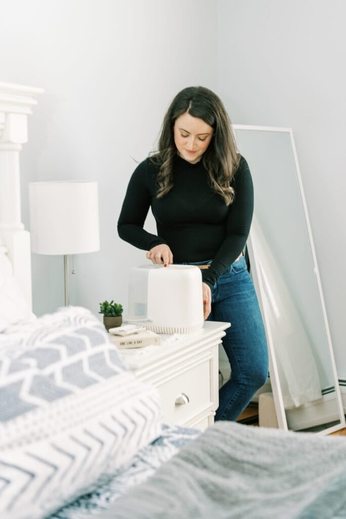 A girl turning on the canopy anti-mold humidifier