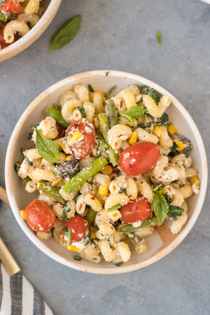A close up of baked feta pasta on a grey background