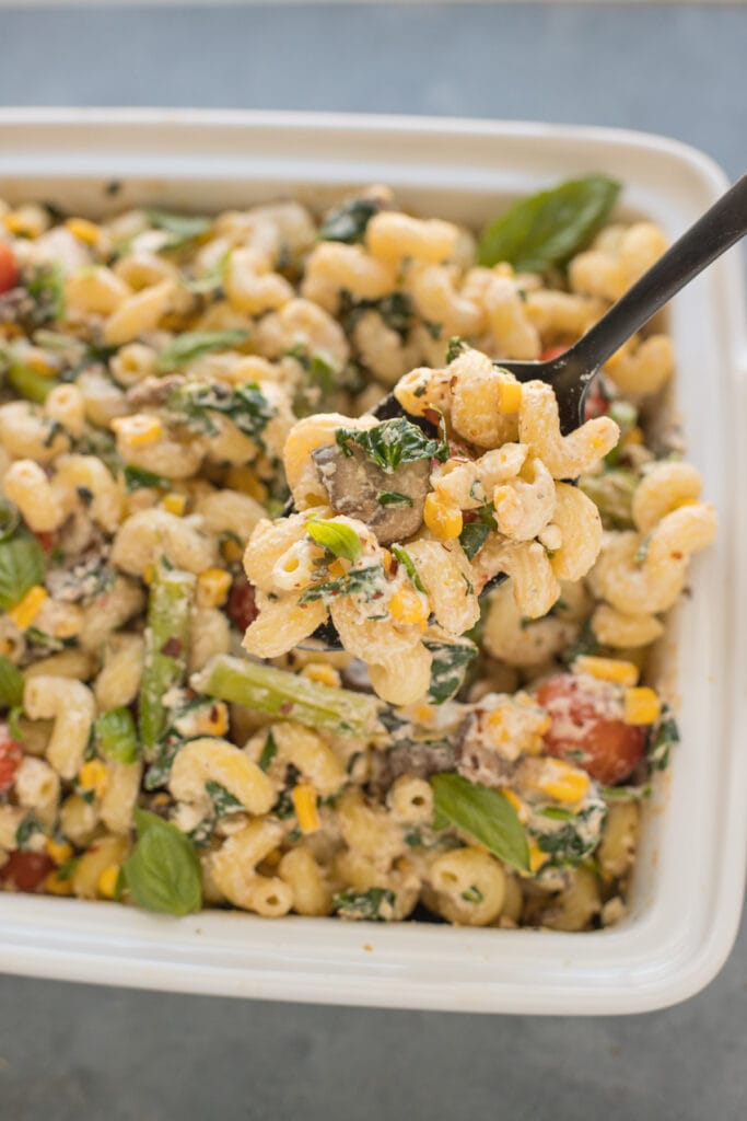 A spoon scooping out a serving of tiktok feta pasta