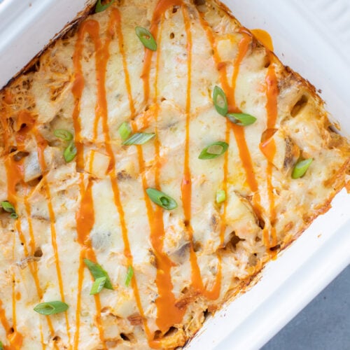 An overhead image of Buffalo Chicken Casserole in a white dish on a grey background
