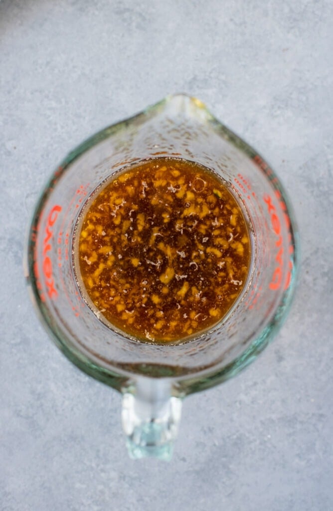 Stir fry sauce being nixed together in a small glass measuring cup
