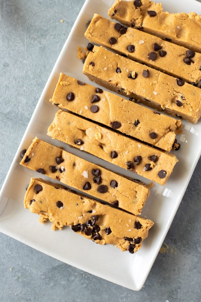 A close up of homemade protein bars on a white dish on a grey background
