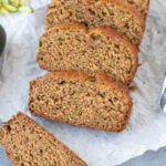 Zucchini Banana Bread Recipe sliced on a piece of parchment paper
