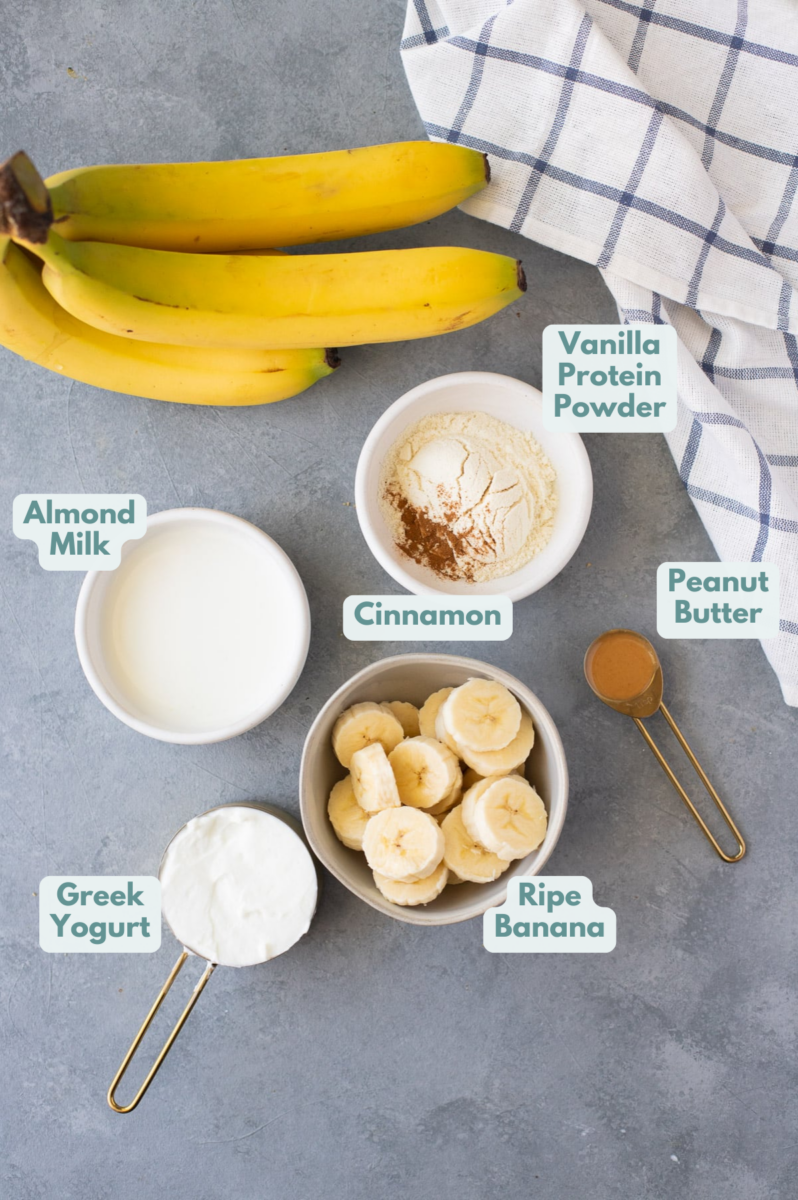 Ingredients for a banana smoothie: bananas, peanut butter, greek yogurt, almond milk, protein powder, cinnamon