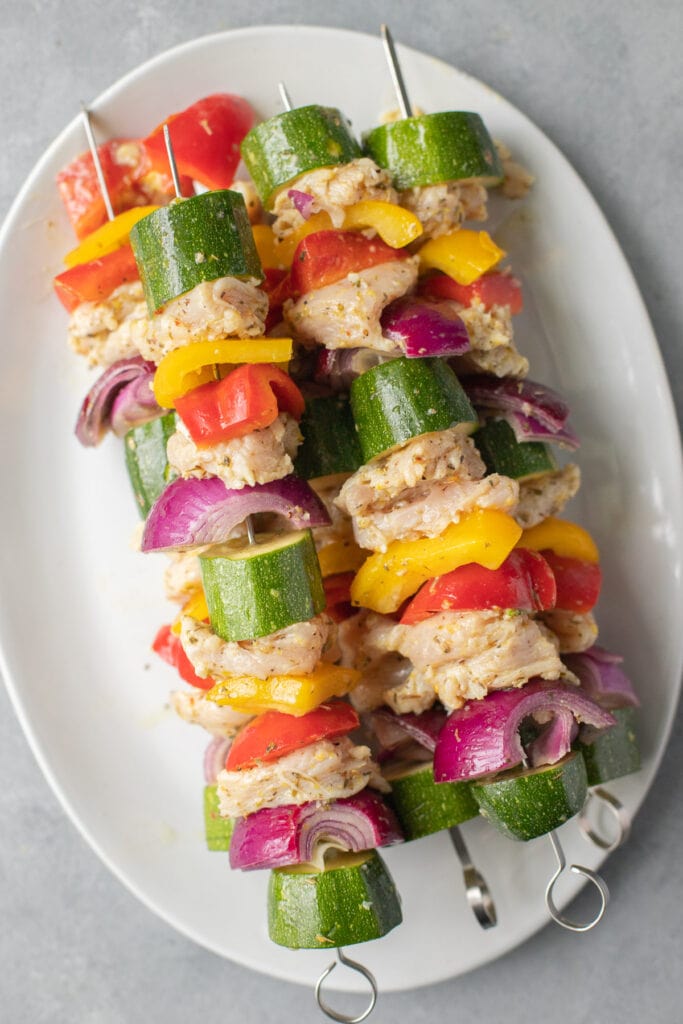 Greek Chicken Kabobs on a skewer before being grilled