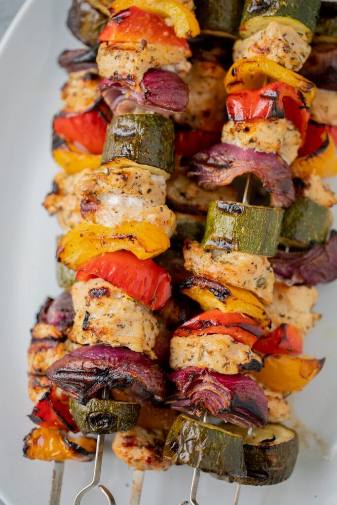 Greek Chicken Kabobs Recipe on a white platter after coming off of the grill