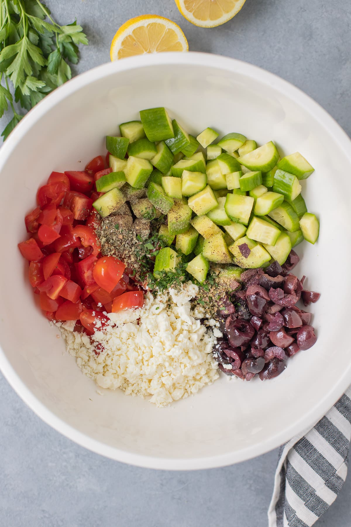 Greek Salad in a white bowl chopped up but not stirred together
