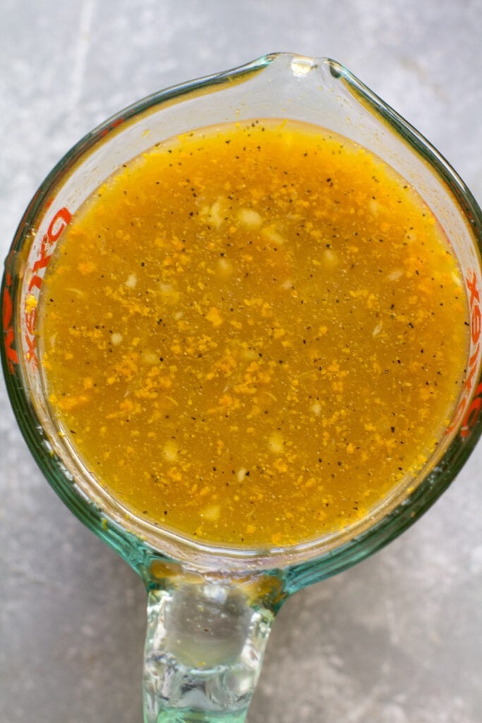 Sauce for healthy orange chicken being mixed together in a measuring cup