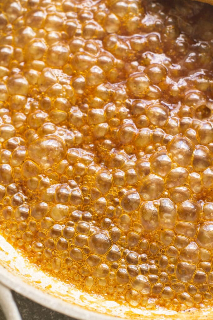 sauce for orange chicken boiling and thickening in a pot