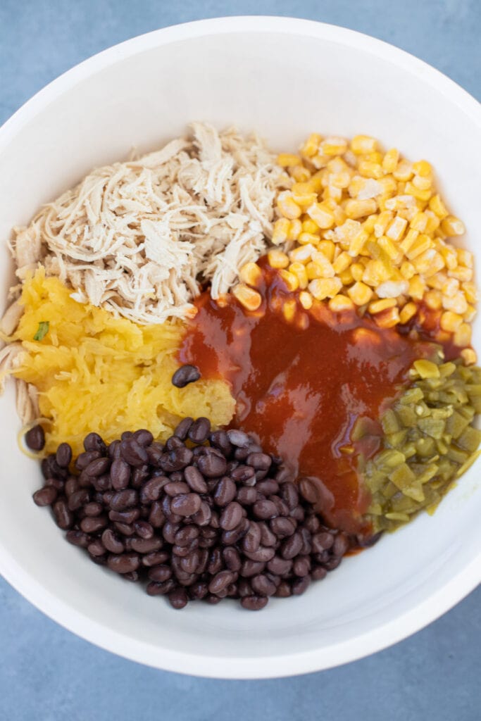 Ingredients for spaghetti squash casserole in a bowl before being mixed together