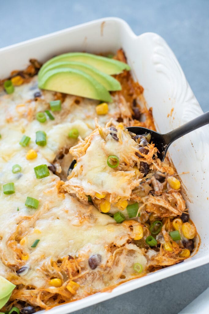 A black spoon scooping out a serving of healthy spaghetti squash casserole
