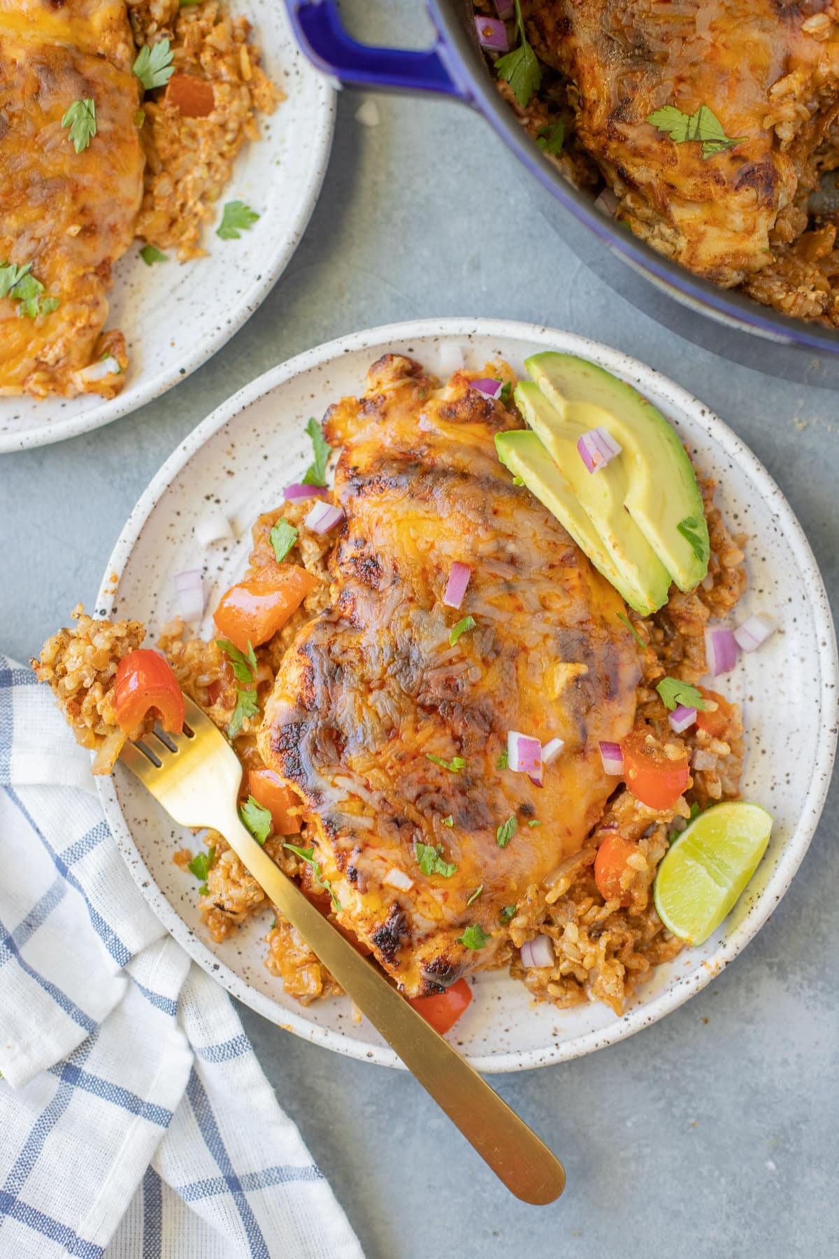 Overhead view of baked chicken casserole made with brown rice, red bell peppers, and onions
