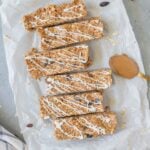 An overhead image of Oatmeal Raisin Protein Bars on a piece of parchment paper on a grey background