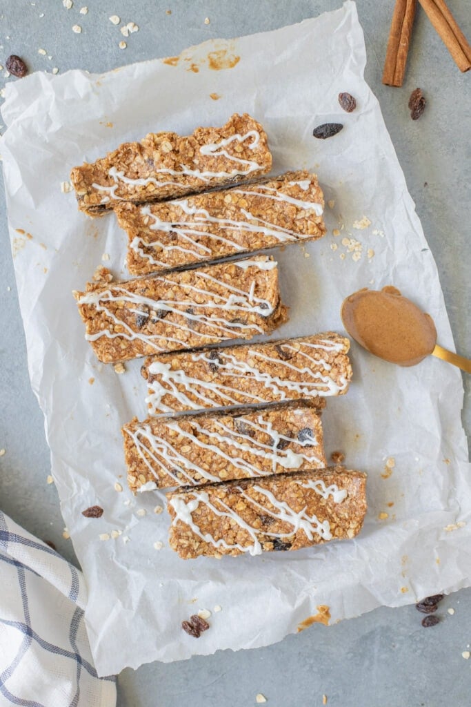 An overhead image of Oatmeal Raisin Protein Bars on a piece of parchment paper on a grey background