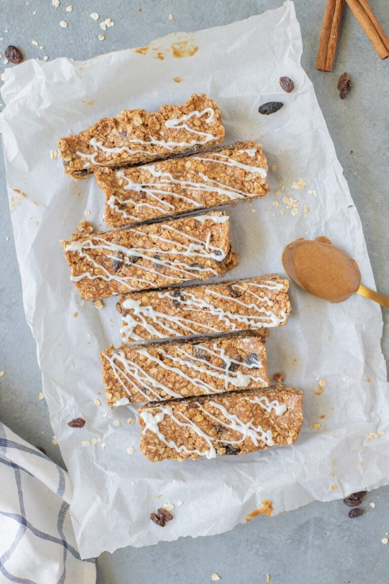 An overhead image of Oatmeal Raisin Protein Bars on a piece of parchment paper on a grey background