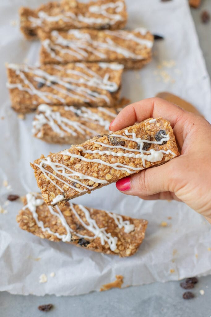 A hand holding a oatmeal raisin healthy protein bars