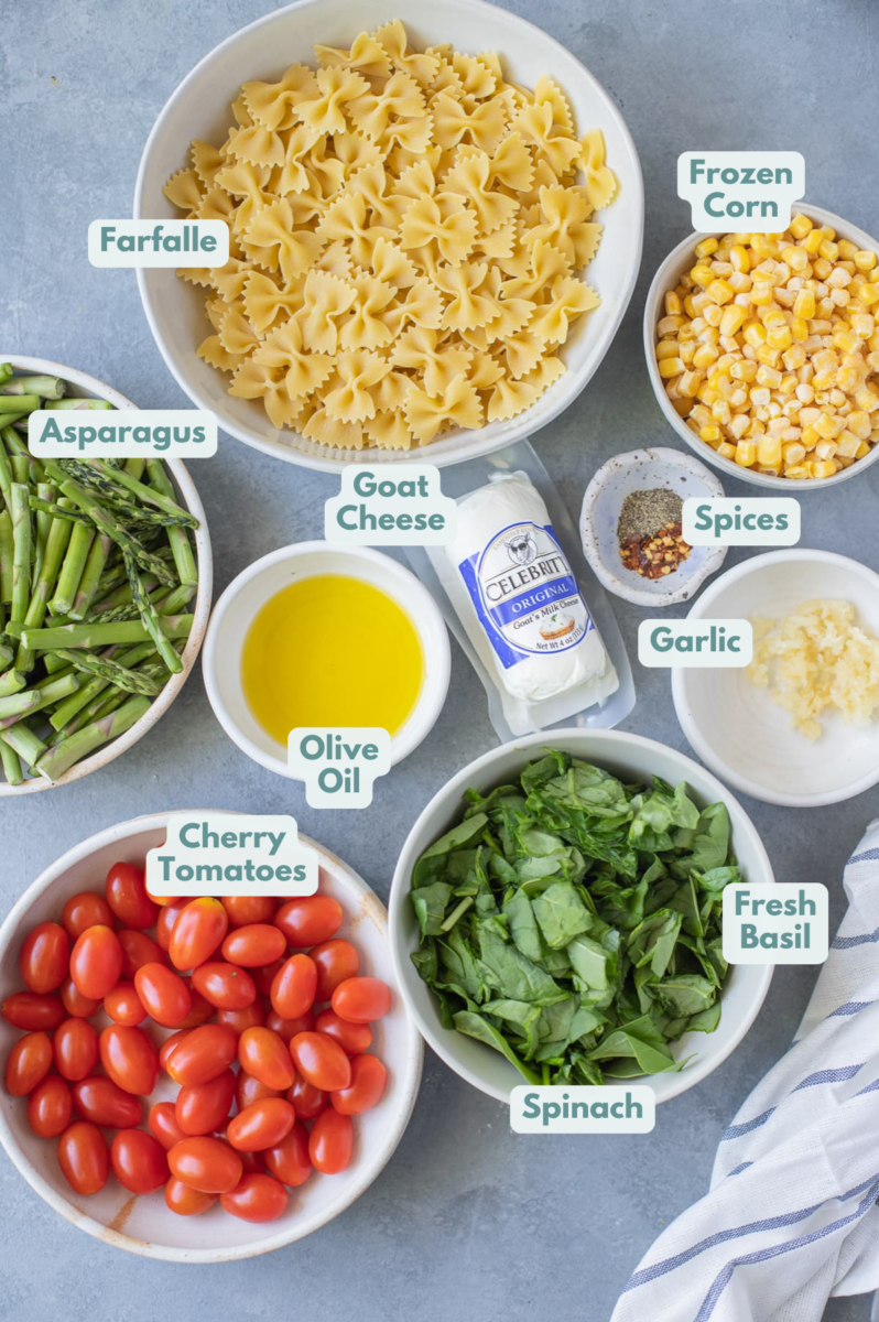 Ingredients for Goat Cheese Pasta in small white bowls - pasta, corn, goat cheese, vegetables, olive oil and tomatoes