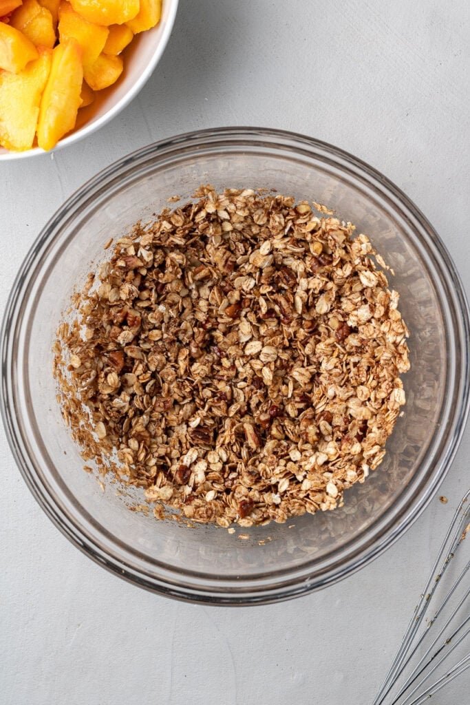 Peach crisp topping in a glass bowl whisked together