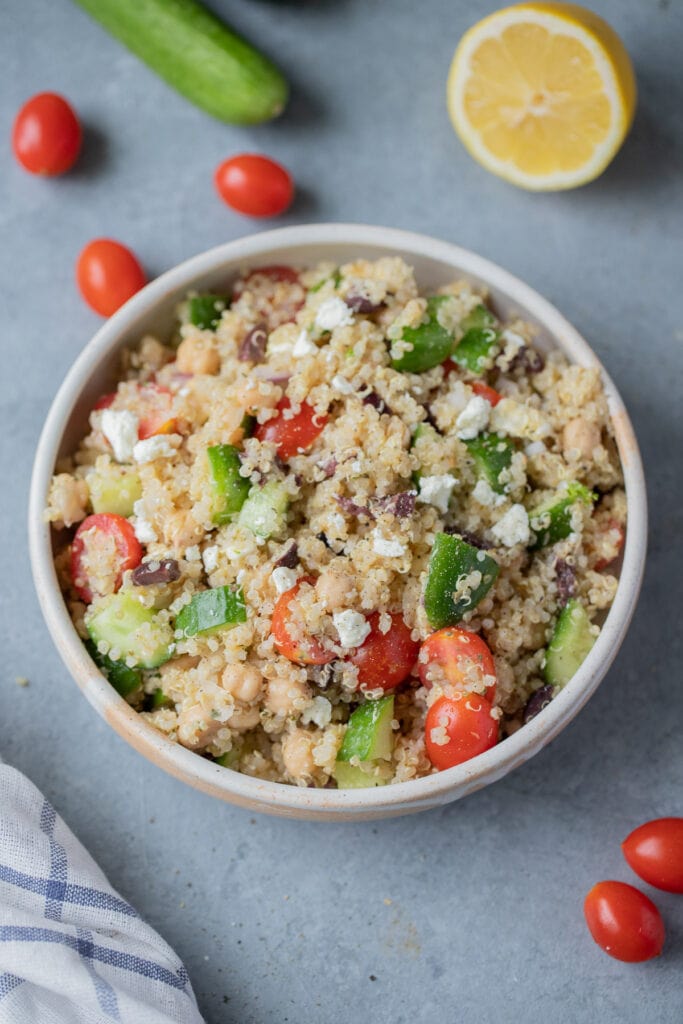 a dish of Mediterranean quinoa salad on a grey background