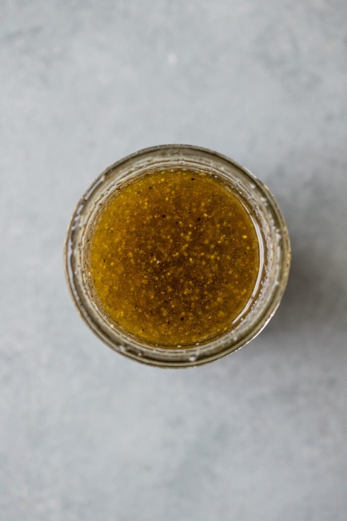 A close up of honey poppyseed dressing for an easy strawberry salad