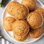 Healthy Zucchini Muffins on a white plate on a grey background